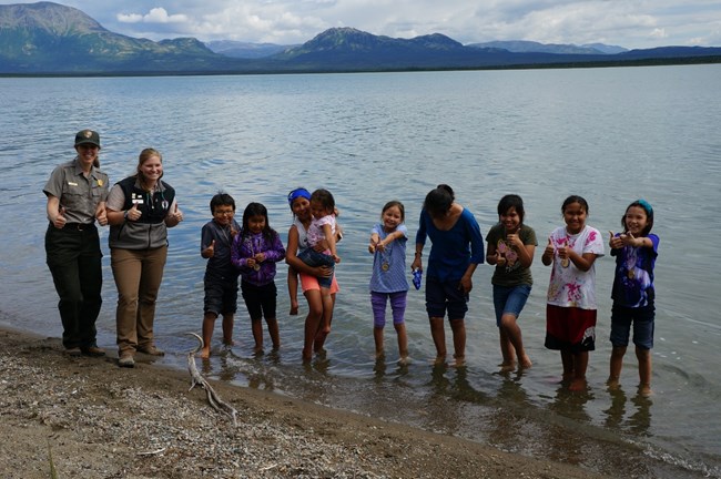 Lake Clark’s Village Day Camp Program campers and park staff stand at the beach