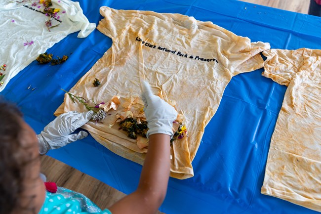 person dyeing a t shirt on a table