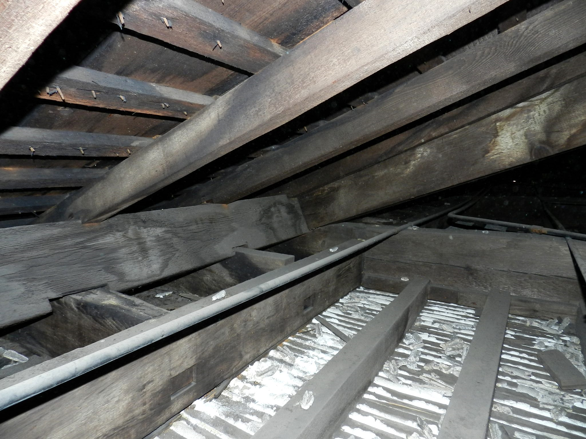 Plaster ceiling with lath construction. Wooden beams with white plaster in-between.