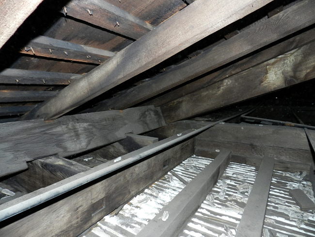 Plaster ceiling with lath construction. Wooden beams with white plaster in-between.