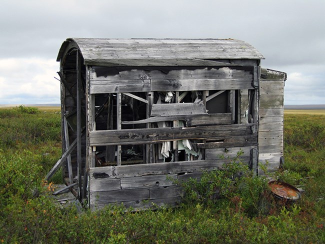 Small wooden structure with rounded roof at the Lava Lake weather station site