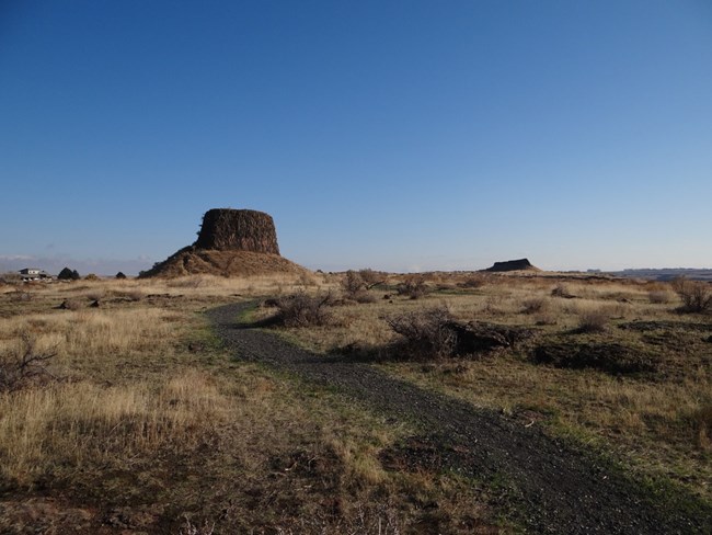 trail leading to large rock with a flat top