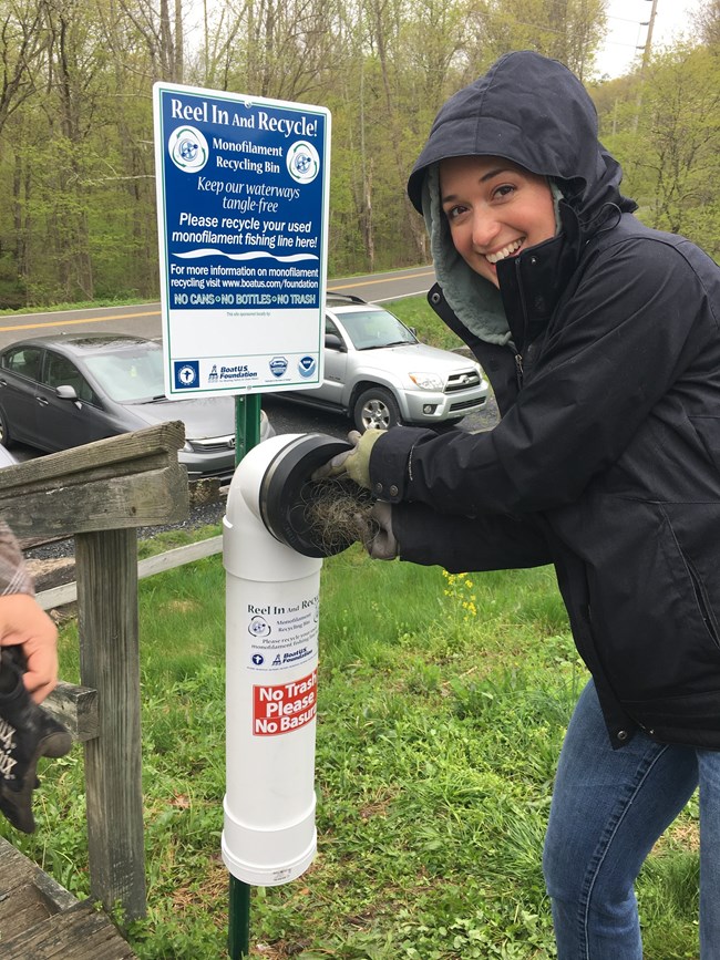 A woman throws away fishing line