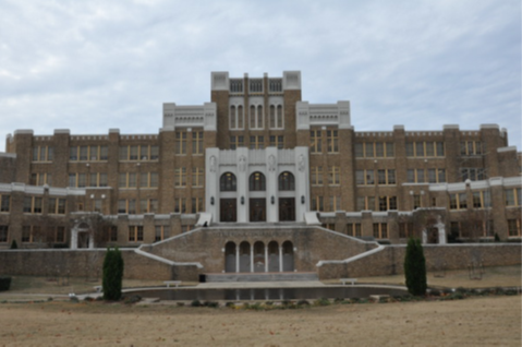 Little Rock High School facade Brown and white building.