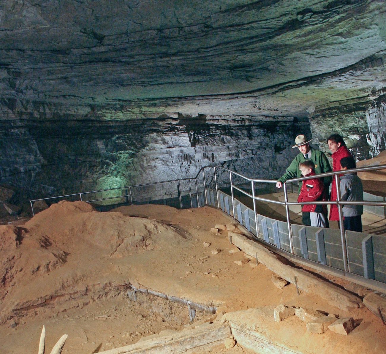 visitors with ranger underground in a cave