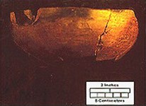 Pieces of brown, unglazed earthenware pieced into a bowl. Pieces of brown, unglazed earthenware pieced into a bowl.