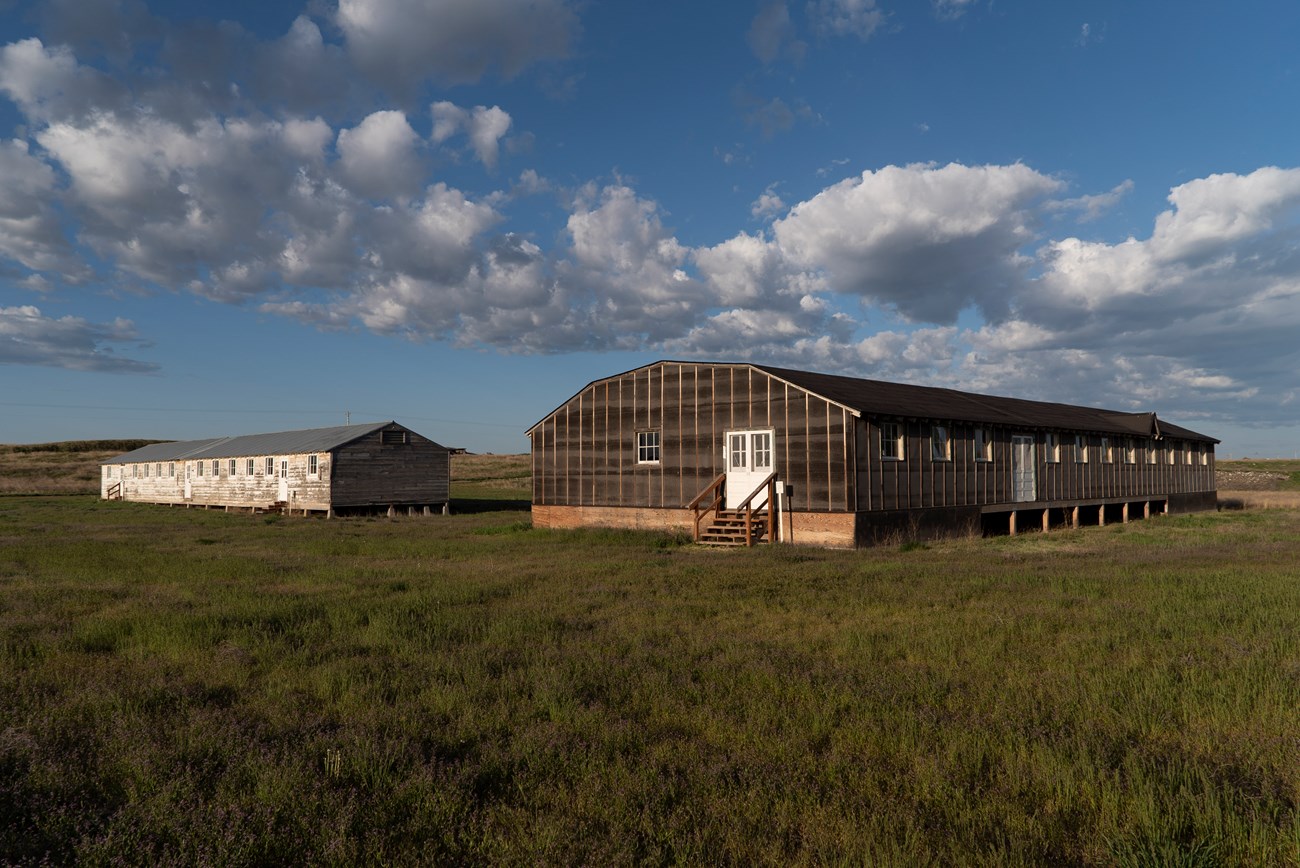 MIIN Block 22 NPS Stan Honda Two long wooden buildings on a grass field