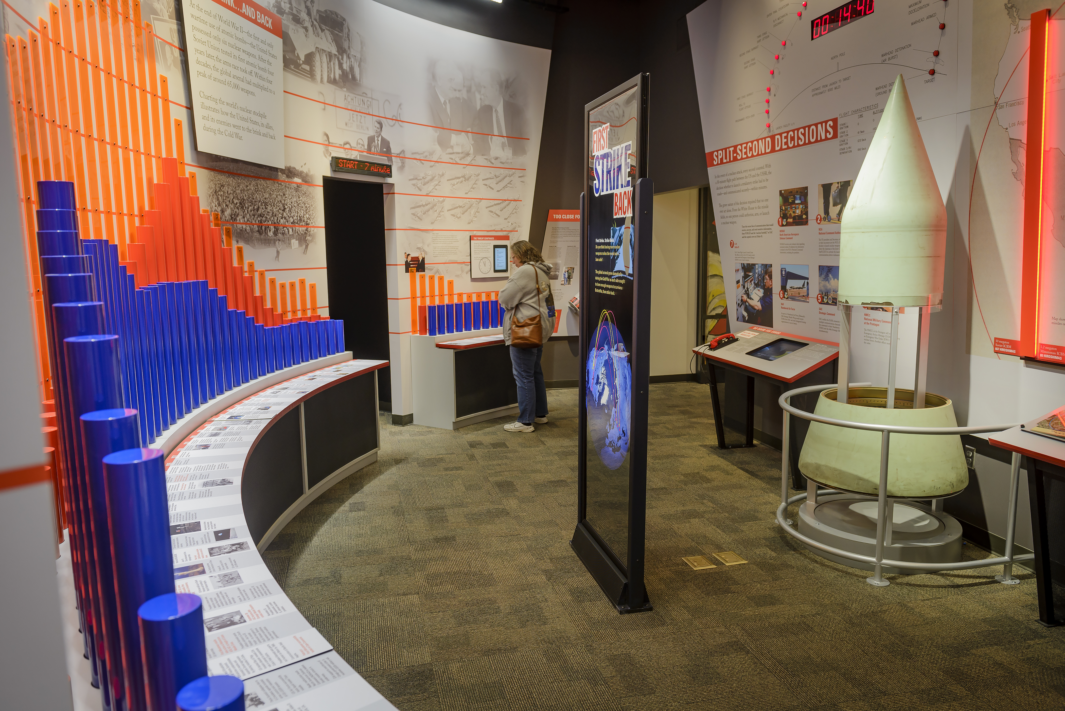 A curved room with historic photographs