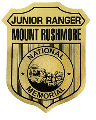 Photo of a Mount Rushmore Junior Ranger badge with a drawing of the sculpture in the center.