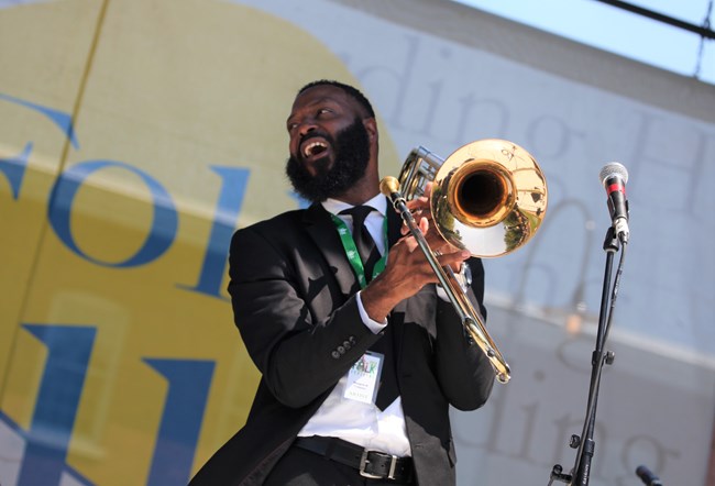 Mangum and Company, Gospel Brass Band A man holds a trumpet