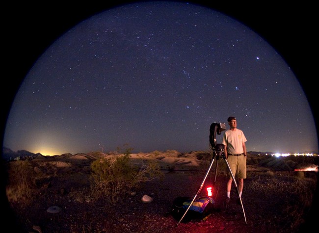 Measuring night light NPS resource specialist Bob Meadows stands beside the specialized CCD camera used to measure all sky brightness.