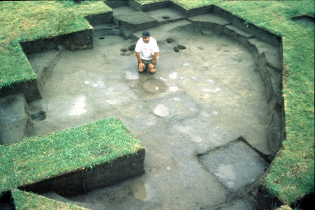 Menoken Indian Village house feature A man sitting in the remnants of an ancient house.