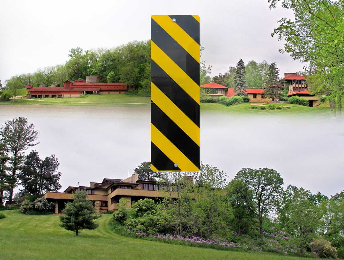 Midway Farms, hillside Studio and Theater, and Taliesin sites. Red buildings on a hill and a brown building on a hill with a yellow and black rectangle sign in the middle.