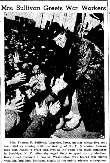 Alleta Sullivan greets employees at shipyards in Brooklyn, New York, after she had urged them to speed war production. grainy newspaper image of a woman in a long fur coat reaching down and shaking hands with a large crowd of men