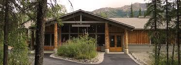 The Murie Science and Learning Center is a quiet log building nestled under coniferous trees.