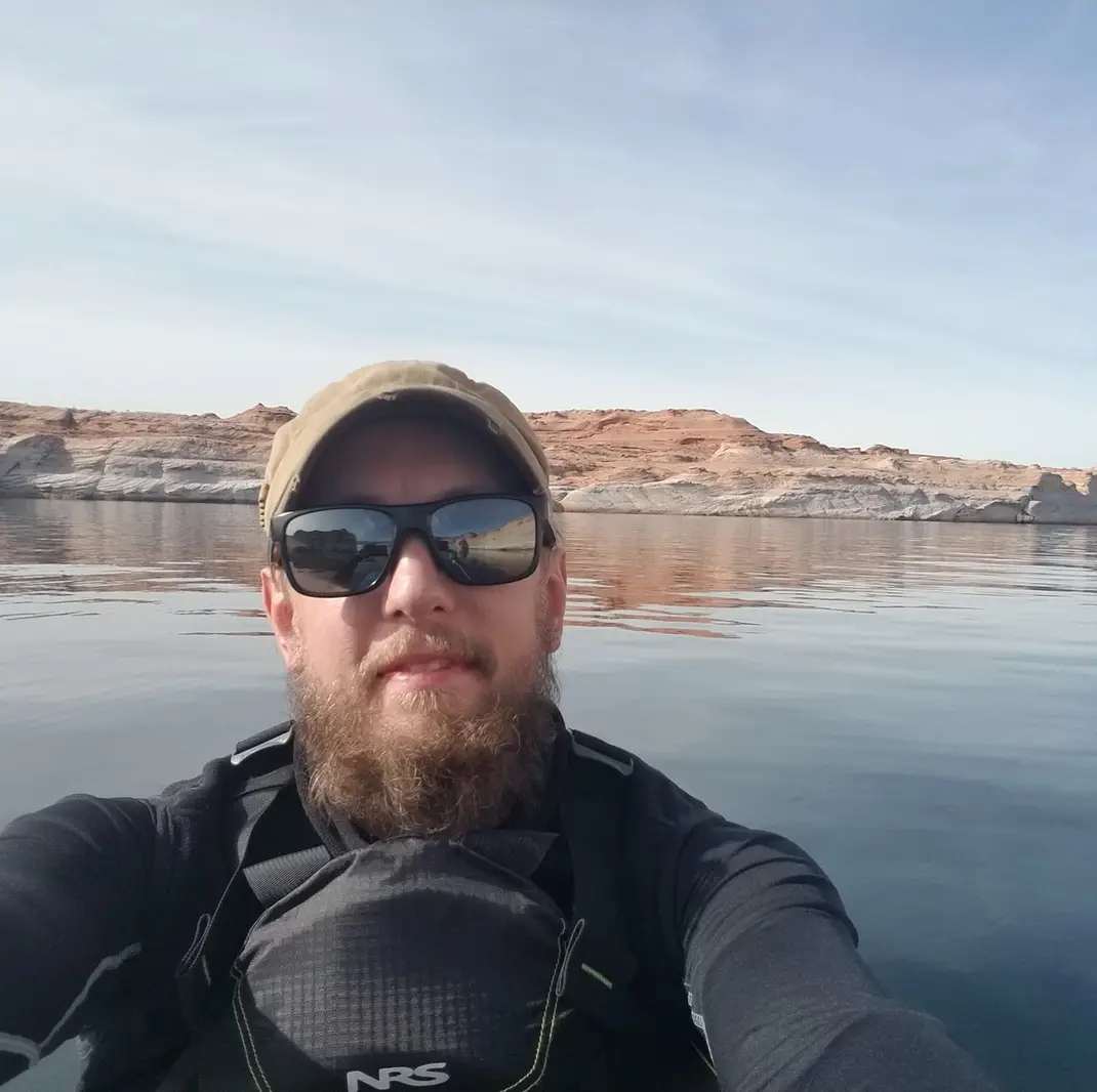 lt= Person selfie image on water wearing a lifejacket