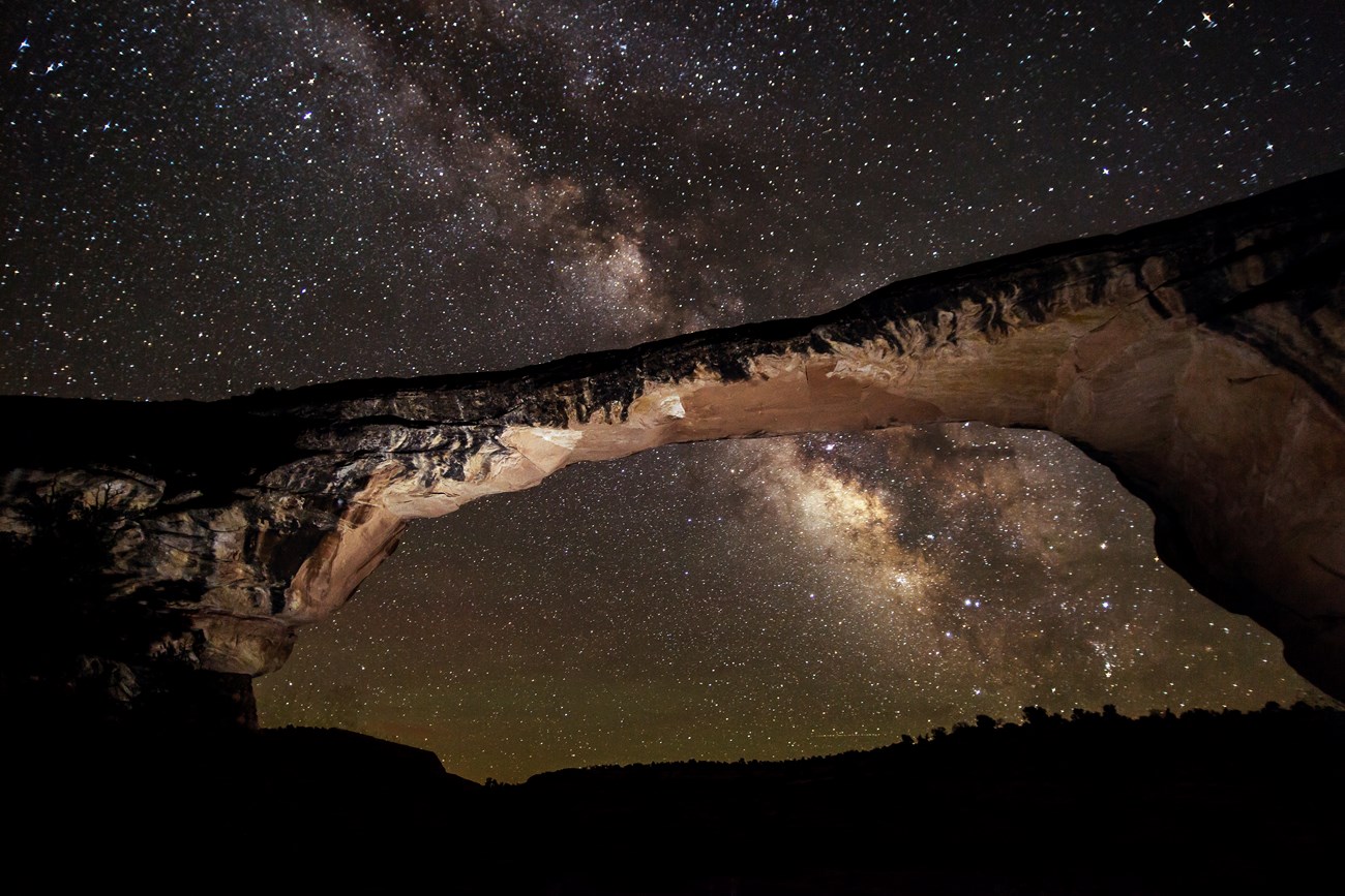 Night sky at Natural Bridges National Monument Dark sky full of stars above and through a land bridge.