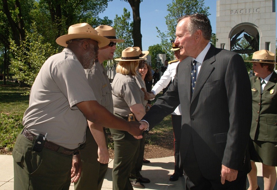 NAMA President Bush (DOI Tami Heilemann) 960 President George H.W. Bush shaking hands with a park ranger at the World War II Memorial