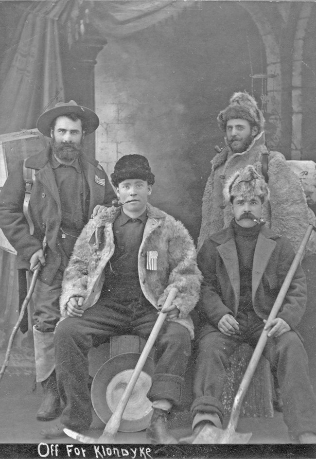 Four men dressed for the Klondike Gold Rush.