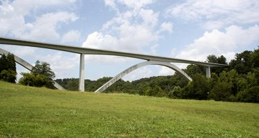 Birdsong Hollow Bridge, a concrete double-arch bridge located 9 miles from the northern terminus of the Natchez Trace Parkway. Birdsong Hollow Bridge