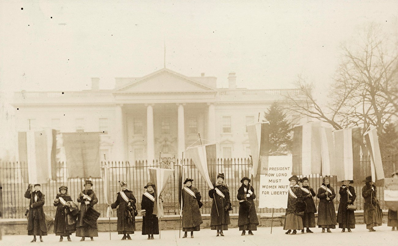 Suffragists rally in front of the White House.