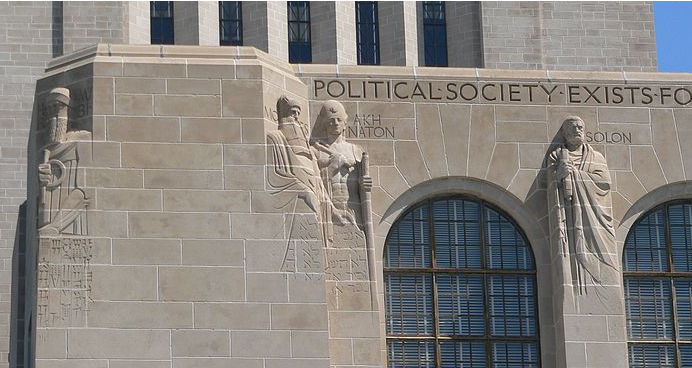 Stone sculpted figures in the side of the Nebraska State Capitol building.