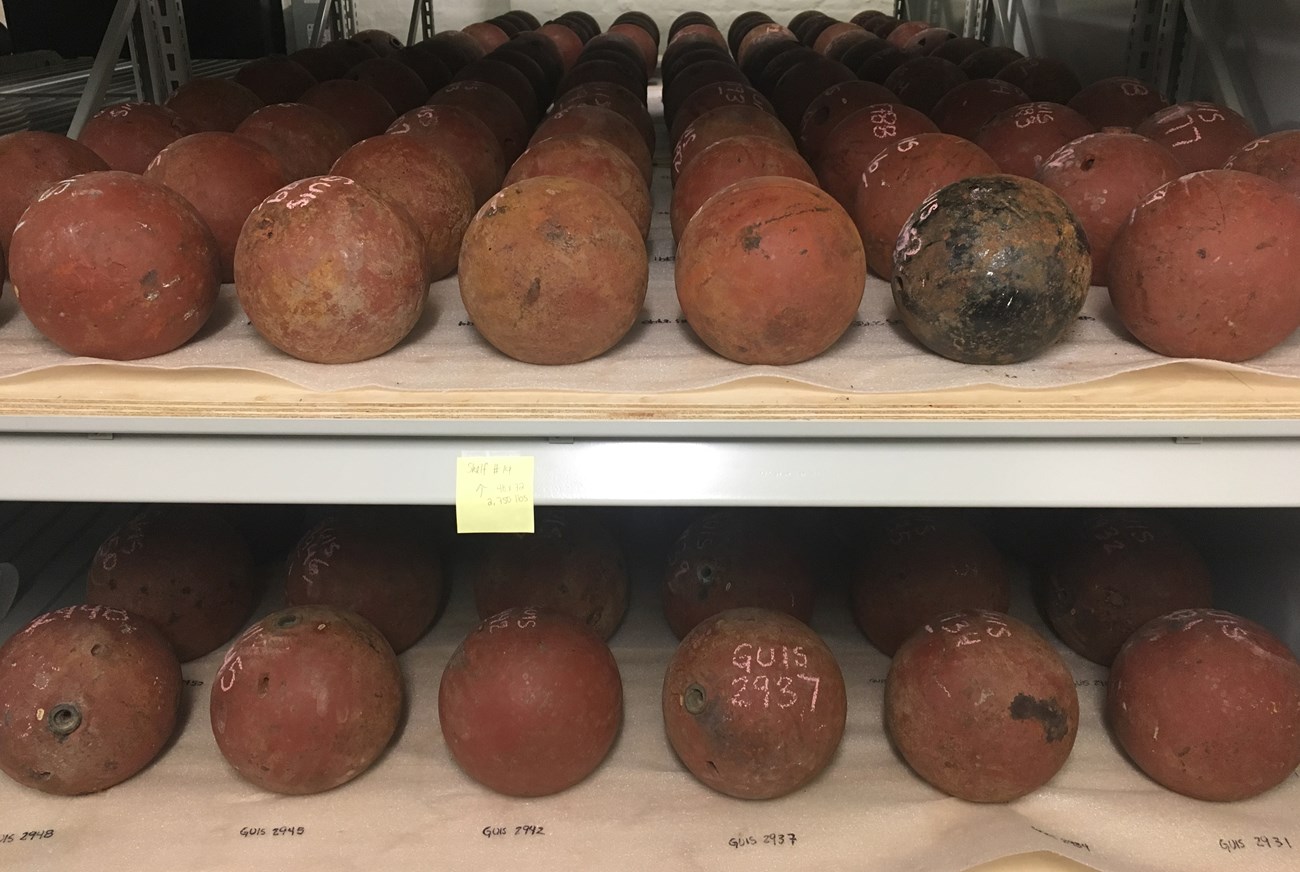 Cannonballs organized by size and type on archival materials. Cannonballs organized by size and type on archival materials.