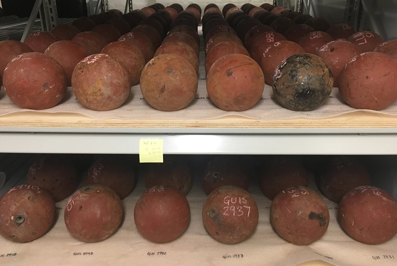 Cannonballs organized by size and type on archival materials. Cannonballs organized by size and type on archival materials.