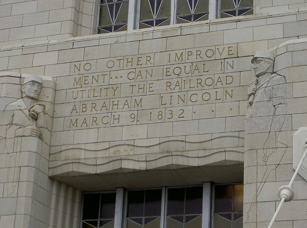 Stone carvings of words and two men into the side of Omaha Union Station.