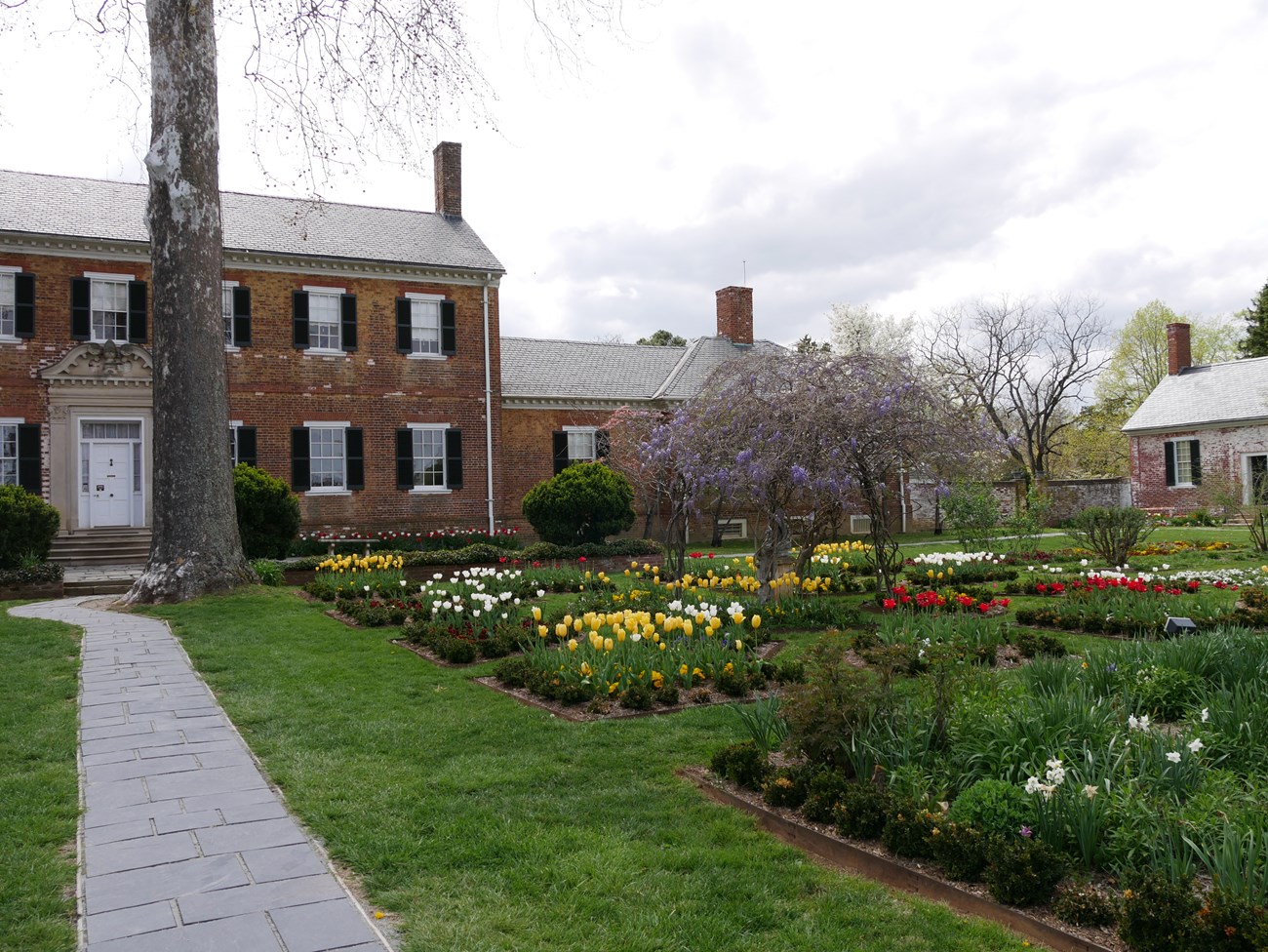 An image showing the a blossoming garden in front of the estate