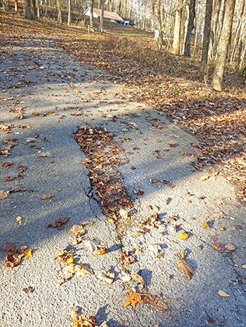 Pothole in the road at Peaks of Otter campground. Pothole in the road at Peaks of Otter campground.