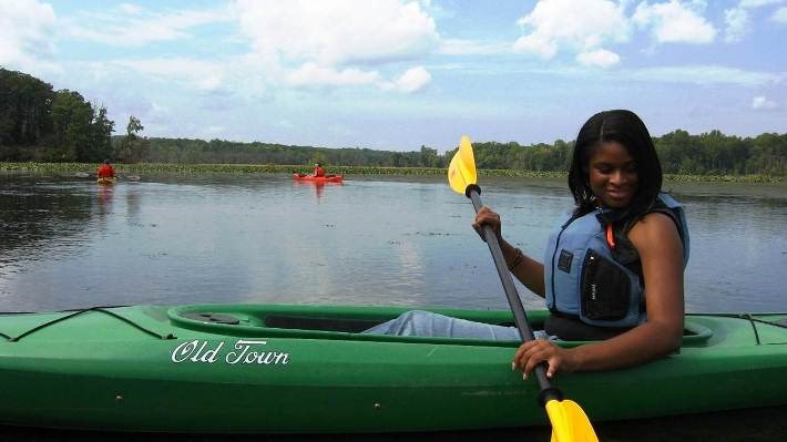 Woman holding paddle in kayak