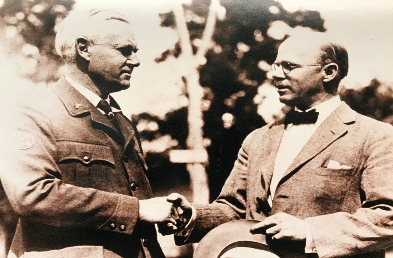 National Park Service Director Stephen Mather with Bureau of Public Roads Western Field Director Lawrence Hewes Shaking Hands.