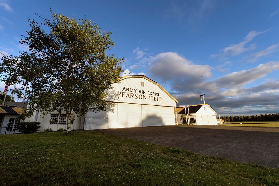 Photo of Pearson Air Museum, a large white building with a yellow and black checkered roof.