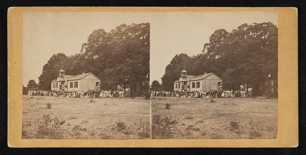 Penn School building with adults and children standing outside Penn School building with adults and children standing outside