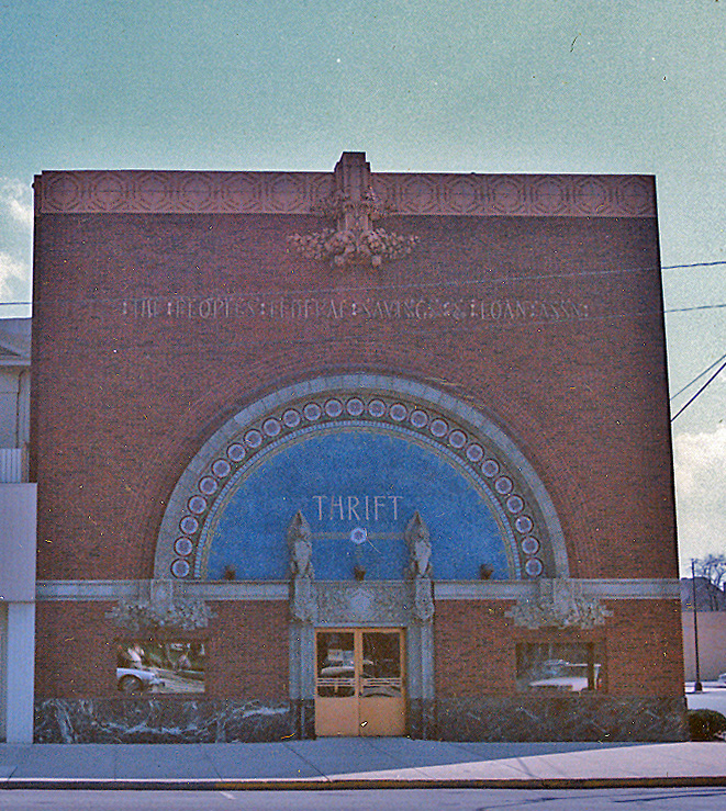 Brick building with a large, arched window.