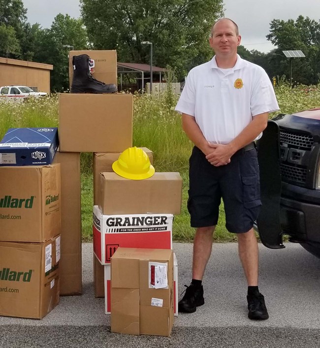 Porter Fire Chief standing with equipment received from grant.
