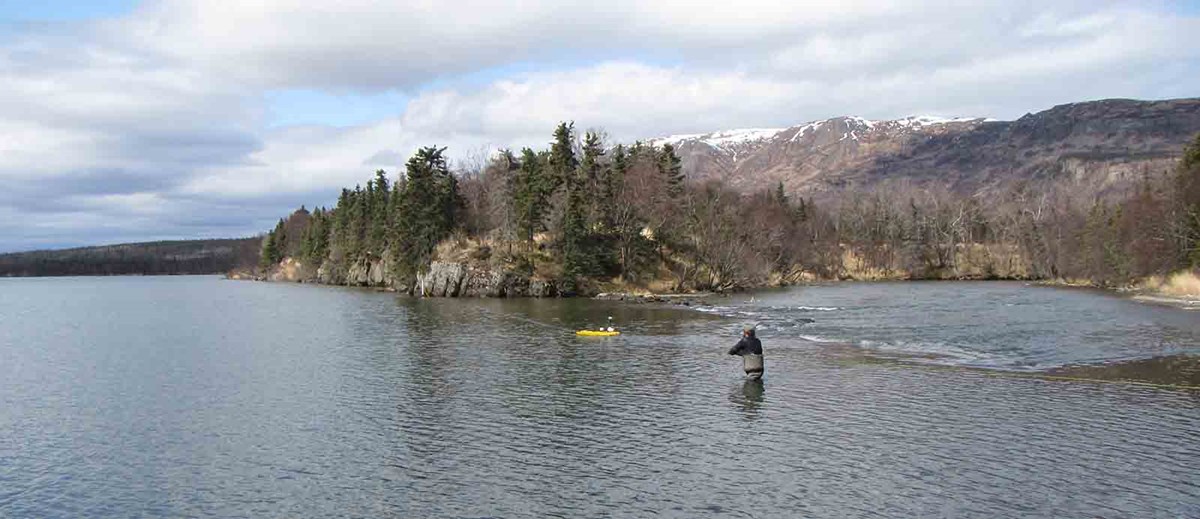 A researcher collecting water quantity data in a lake. A researcher collecting water quantity data in a lake.