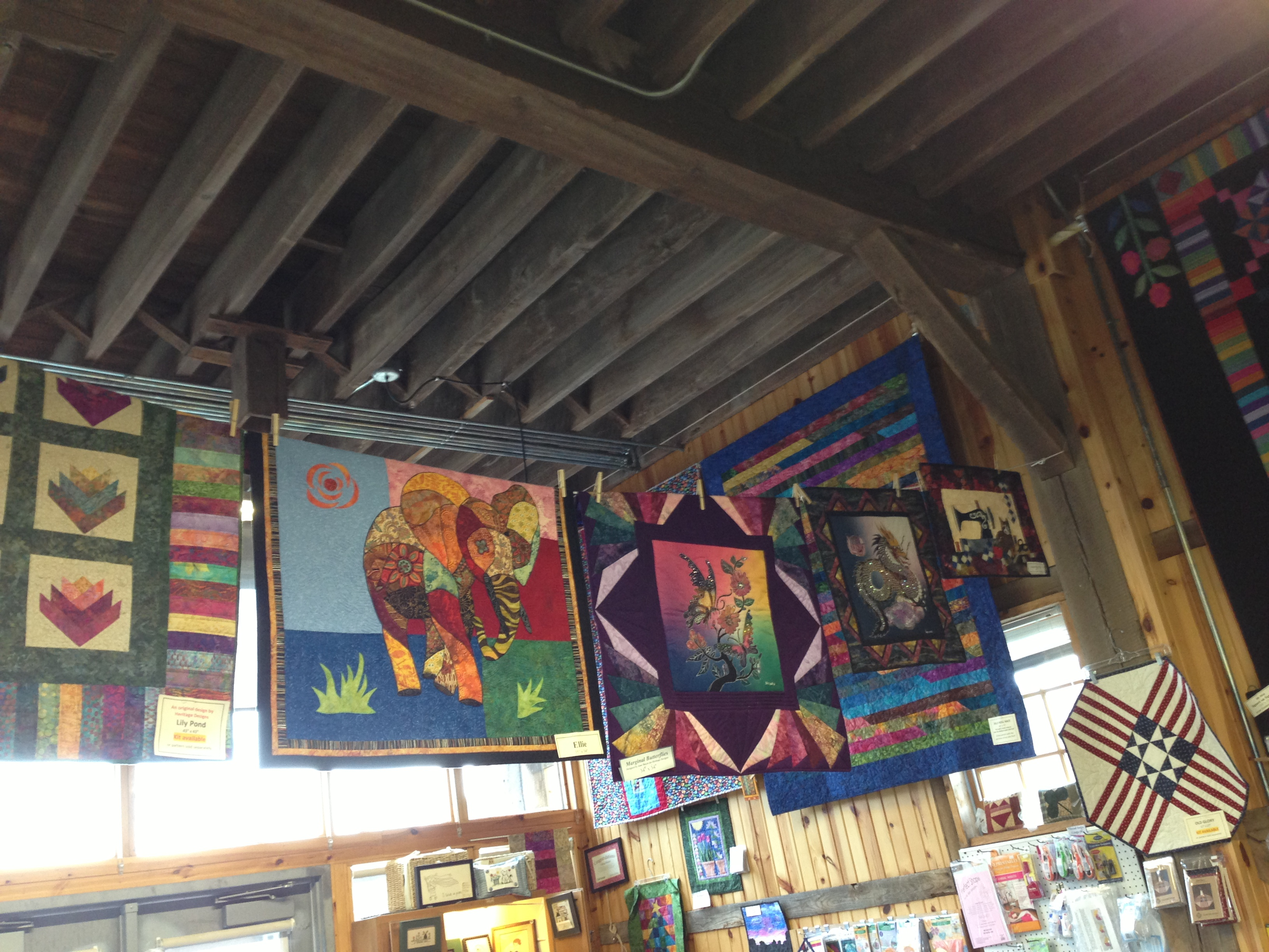 Multi-colored hanging on the walls and from the wooden rafters.