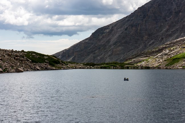Lake sediment core collection from the middle of Pipit Lake Small inflatable boat out in the middle of an alpine lake