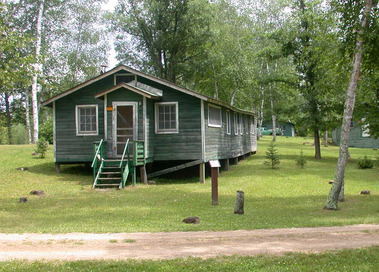 Green building among trees.