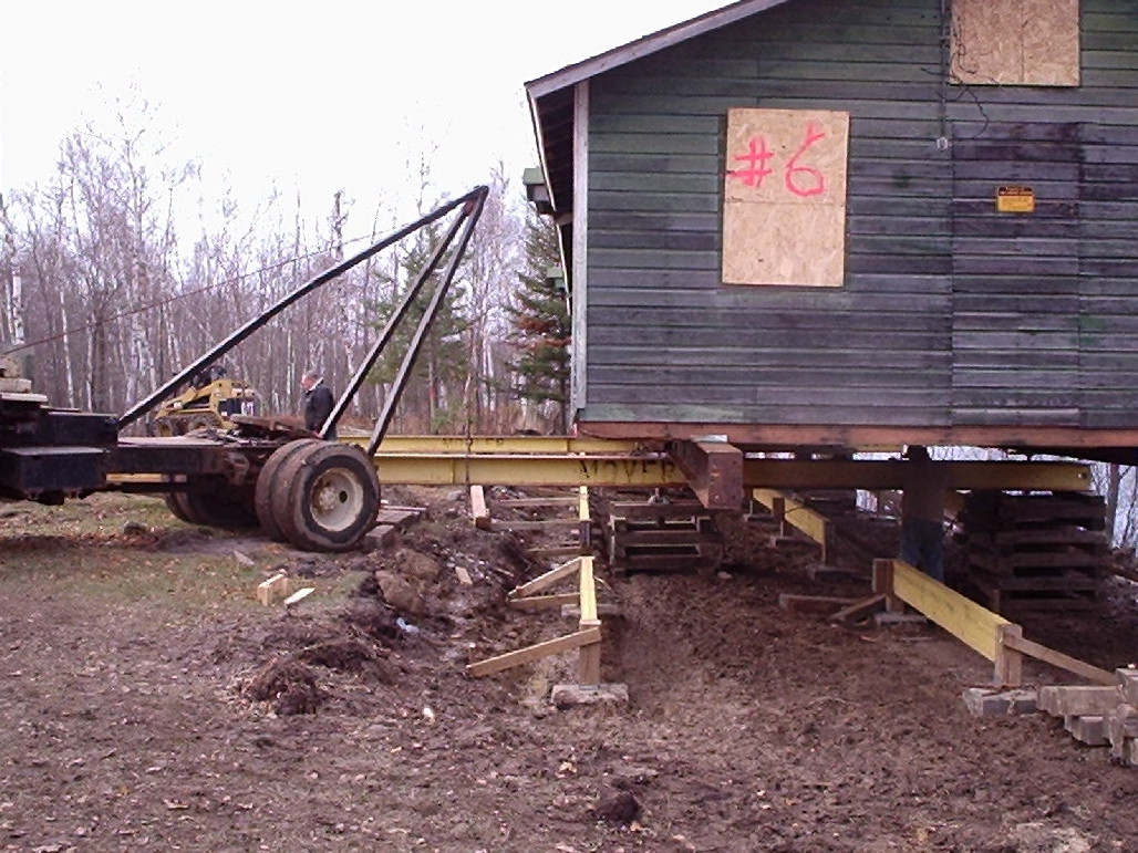 Green building on stilts.