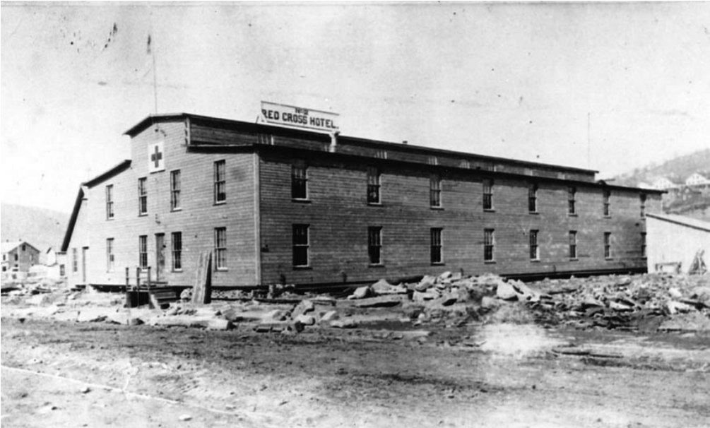 lt= A building with a sign reading "Red Cross Hotel"