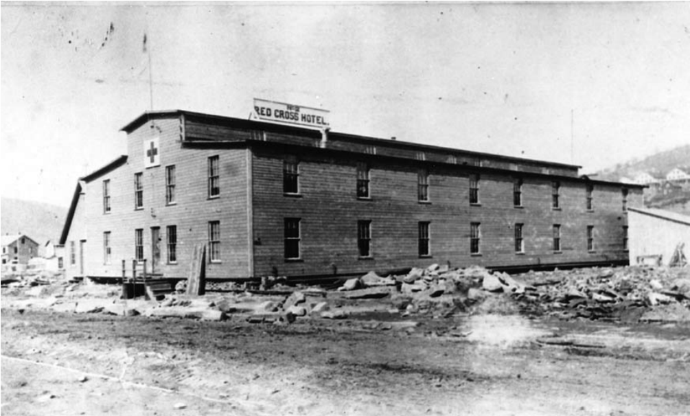 A building with a sign reading "Red Cross Hotel"