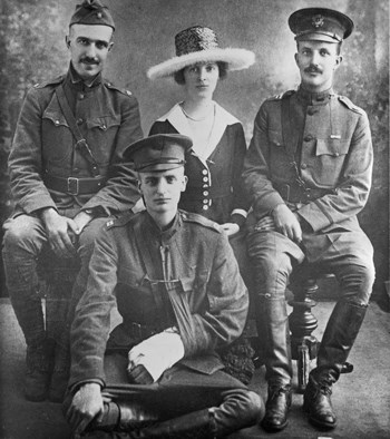 Next-Generation Roosevelts at War Three men in military uniforms and one woman in dress and large hat sit for a photo.