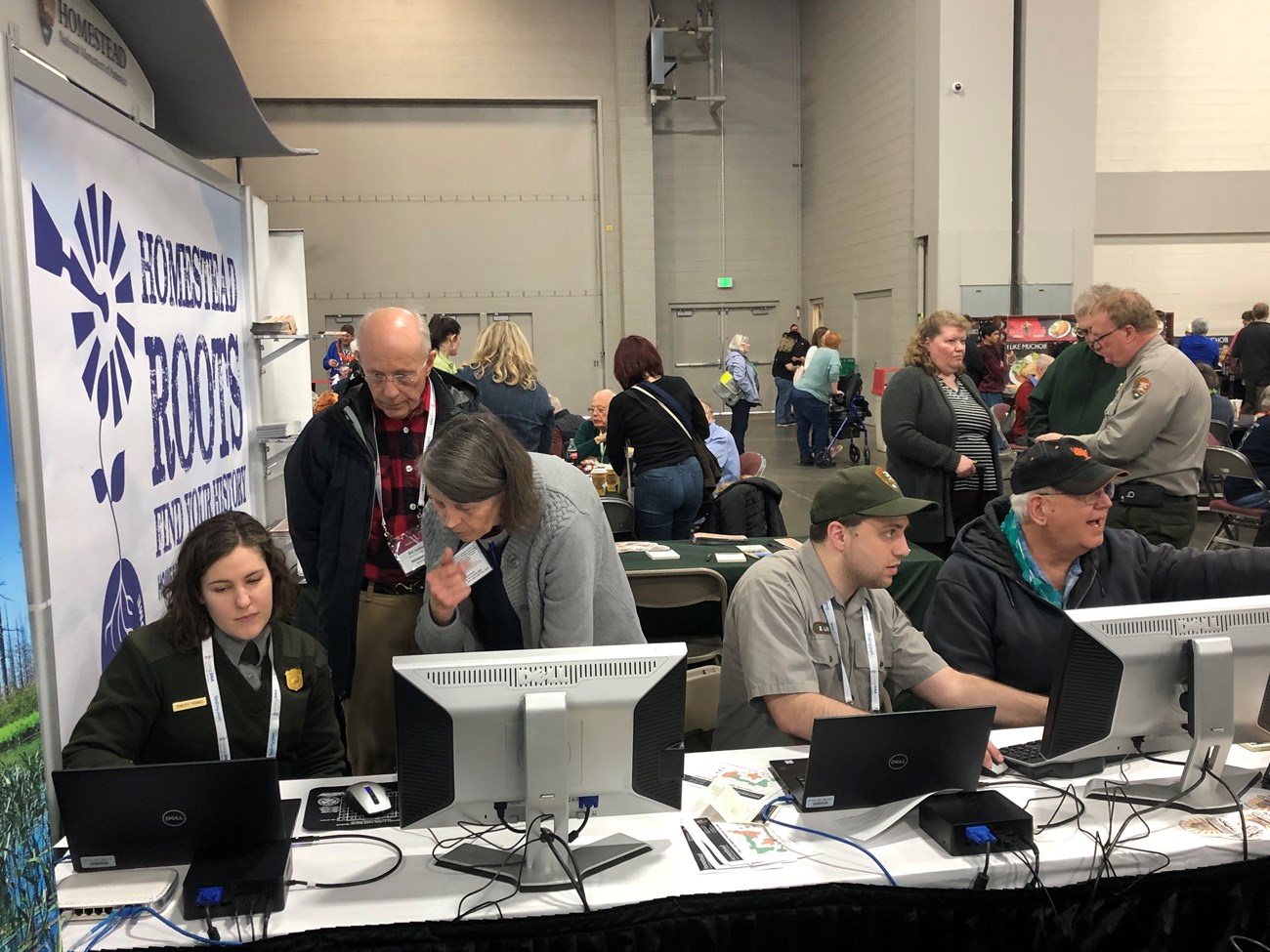 Roots Tech Conference Park staff help visitors navigate online resources to trace family history.