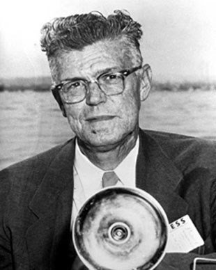 NPS Photographer Abbie Rowe Man in a suit and tie holding a camera