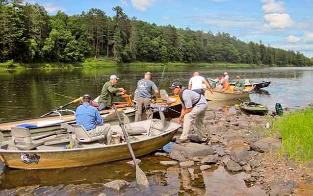 Veterans prepare to launch boats on river.