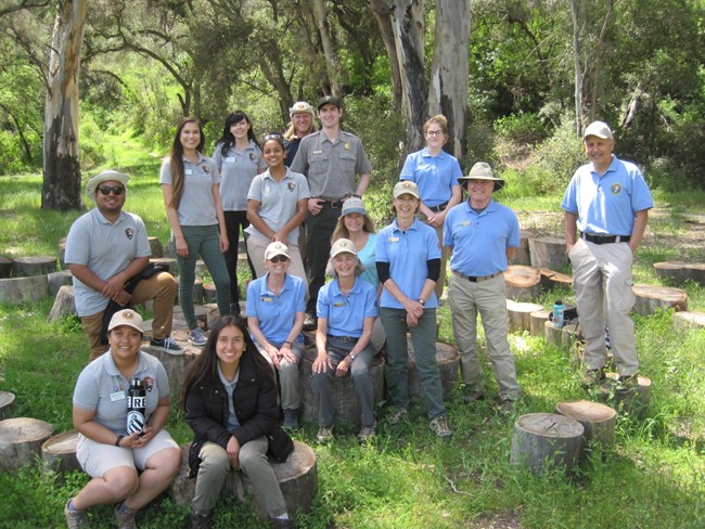 The Education Team at Santa Monica Mountains National Recreation Area. Group of people standing outside wearing volunteer uniforms and smiling.
