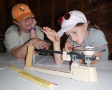 SEAC Archeologist Thadra Stanton providing instruction on weighing artifacts